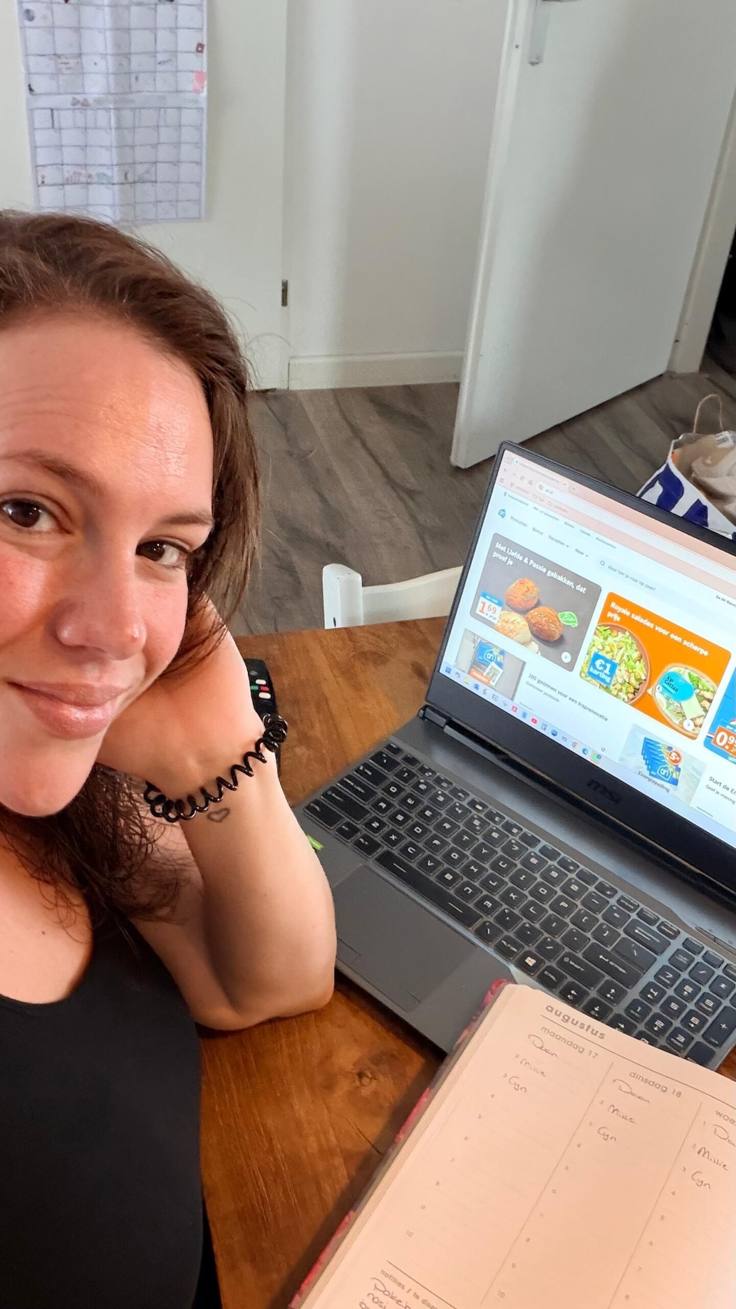 Cynthia bekijkt supermarktproducten achter haar laptop